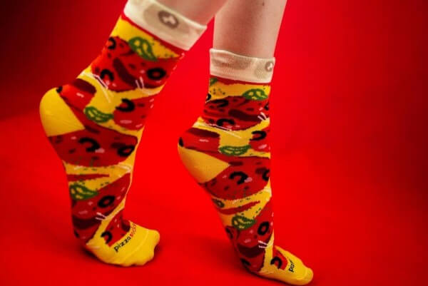 Pizza Socks, feet on tiptoes, red background 